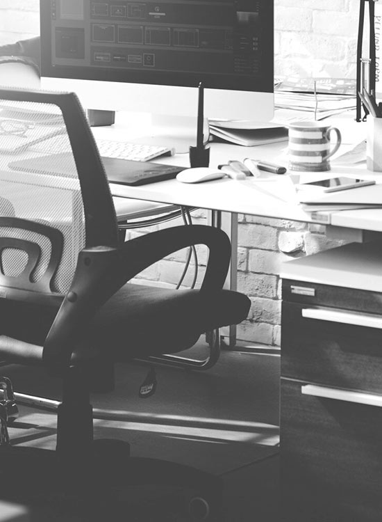 Modern workspace featuring an ergonomic chair, sleek monitor, and a neatly placed coffee cup, designed for productivity and focus.