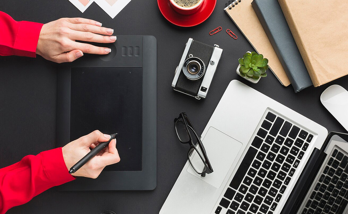 A creative studio workspace featuring tools of design, photography, and digital craftsmanship - representing innovation, expertise, and professional services.